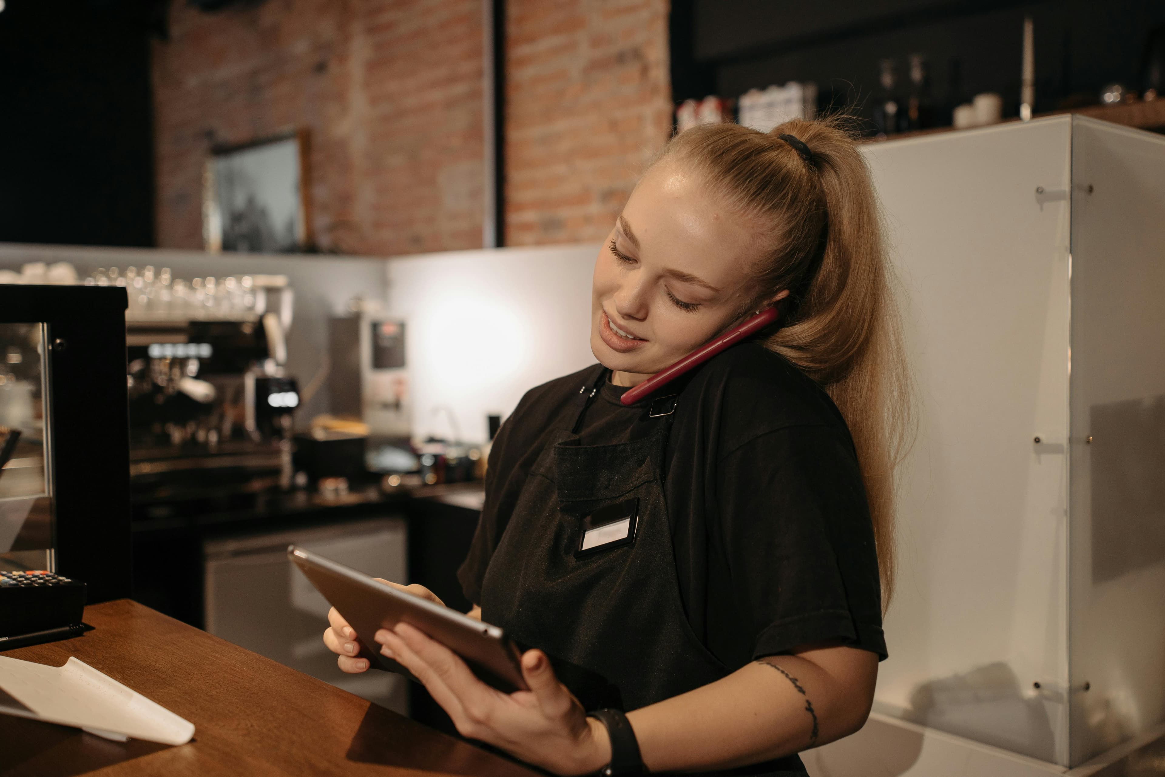 Restaurant manager using RESERVE software on tablet
